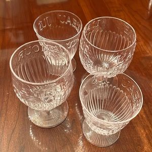 Four small glass French water and whiskey glasses.